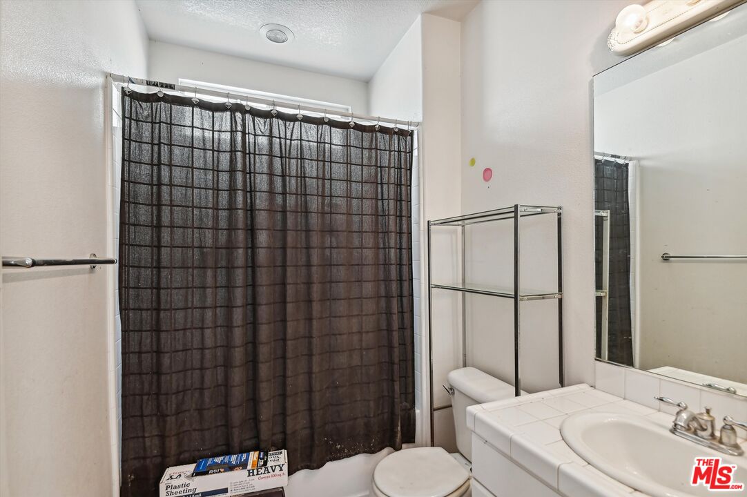 3012 Dunkirk Drive Oxnard, CA 93035 - Photo 25 of 29 a bathroom with a sink toilet and shower