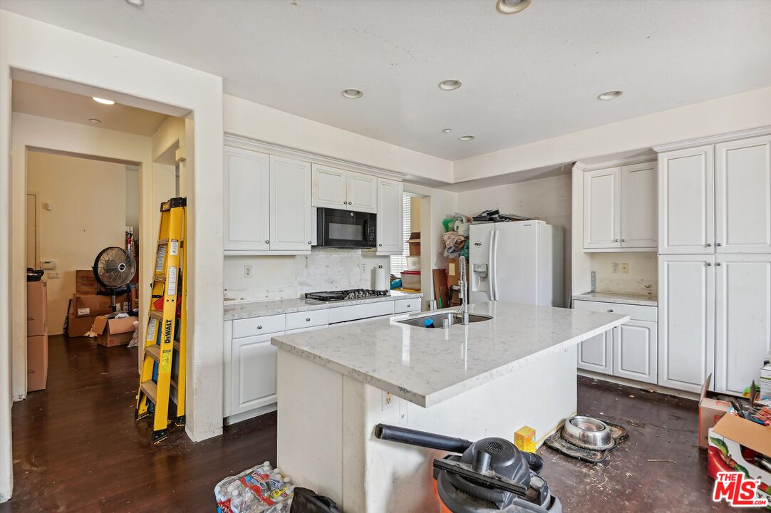 3012 Dunkirk Drive Oxnard, CA 93035 - Photo 4 of 29 a kitchen with stainless steel appliances a sink a stove a refrigerator cabinets and wooden floor