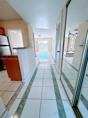 a view of a hallway to a livingroom with furniture