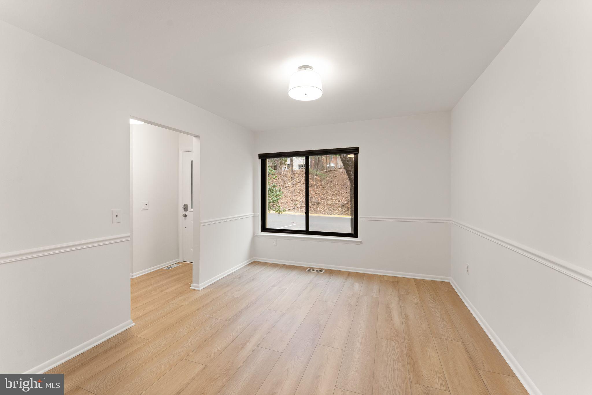 2345 Millennium Lane Reston, VA 20191 - Photo 11 of 55 an empty room with wooden floor and windows