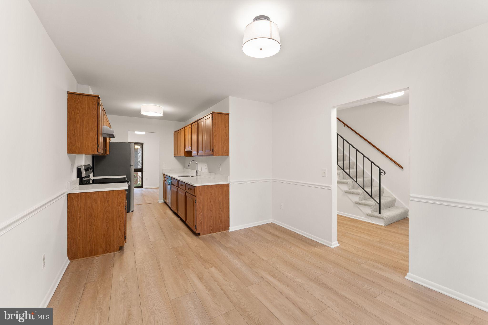 2345 Millennium Lane Reston, VA 20191 - Photo 12 of 55 a kitchen with stainless steel appliances kitchen island wooden cabinets and granite counter tops