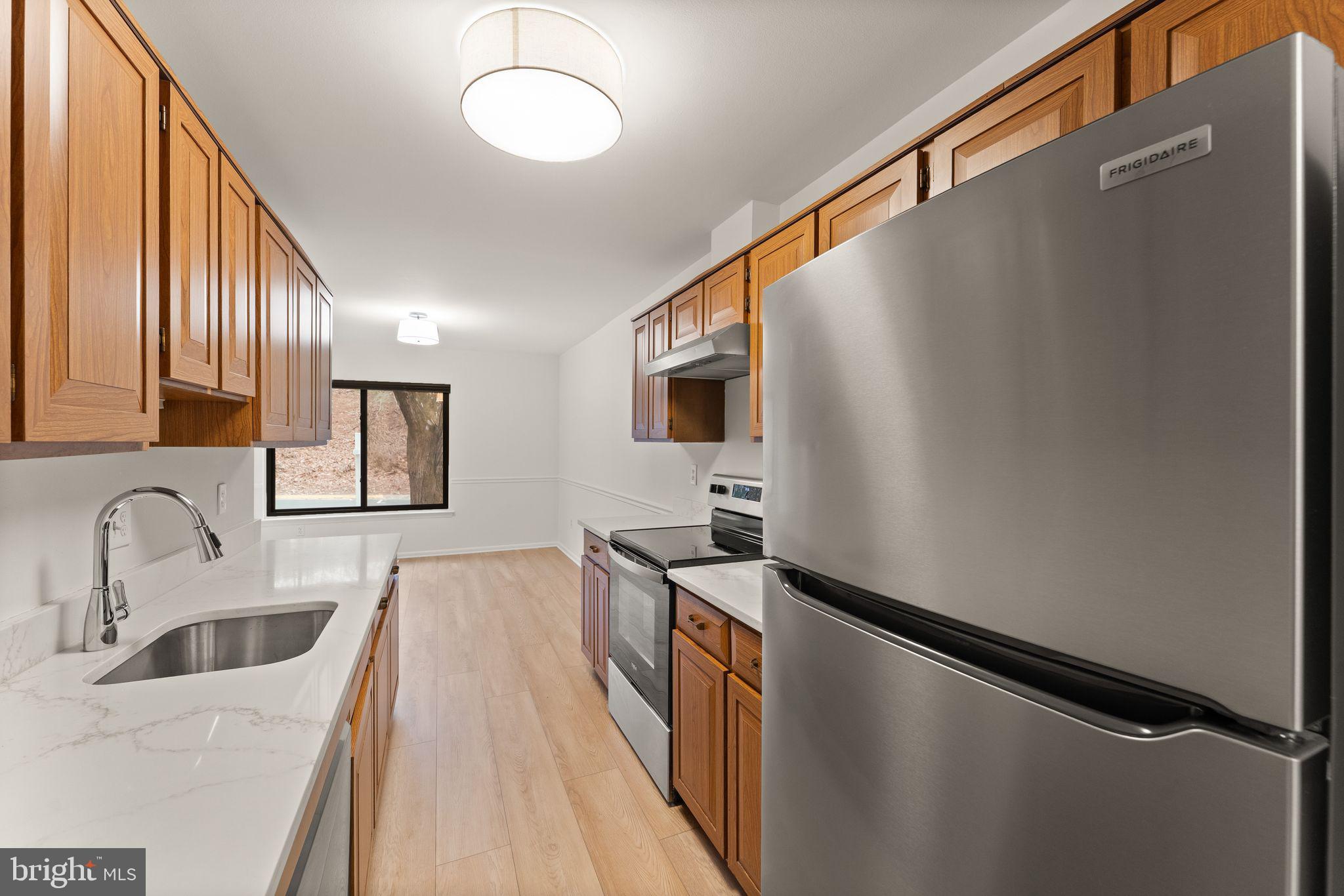 2345 Millennium Lane Reston, VA 20191 - Photo 14 of 55 a kitchen with stainless steel appliances a sink stove and refrigerator
