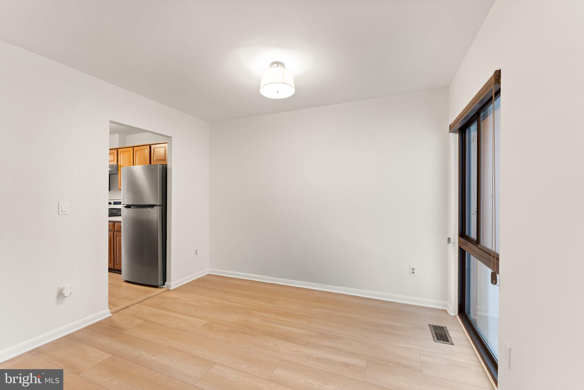 2345 Millennium Lane Reston, VA 20191 - Photo 16 of 55 an empty room with a mirror and wooden floor