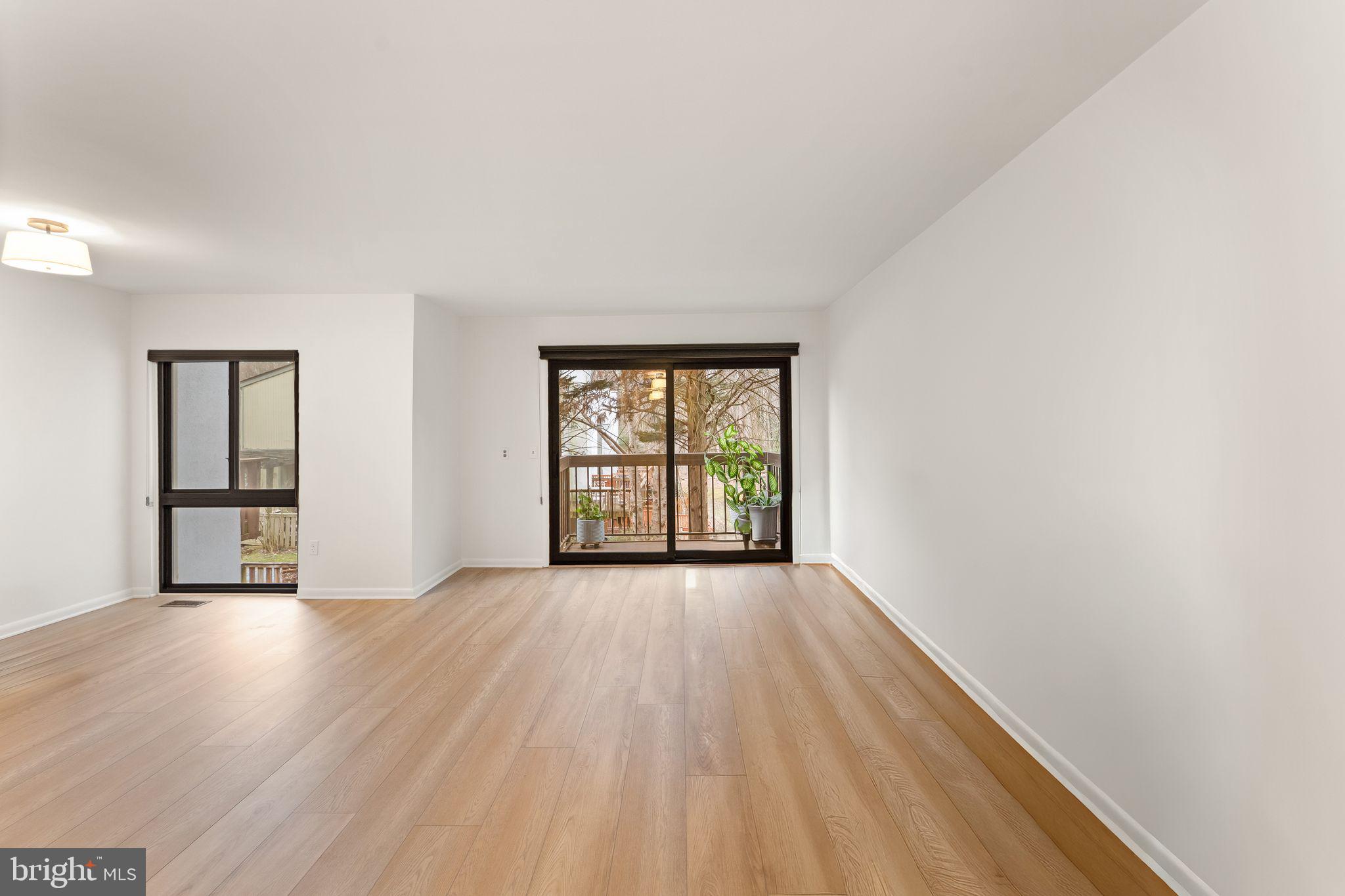 2345 Millennium Lane Reston, VA 20191 - Photo 18 of 55 a view of an empty room with wooden floor and a window