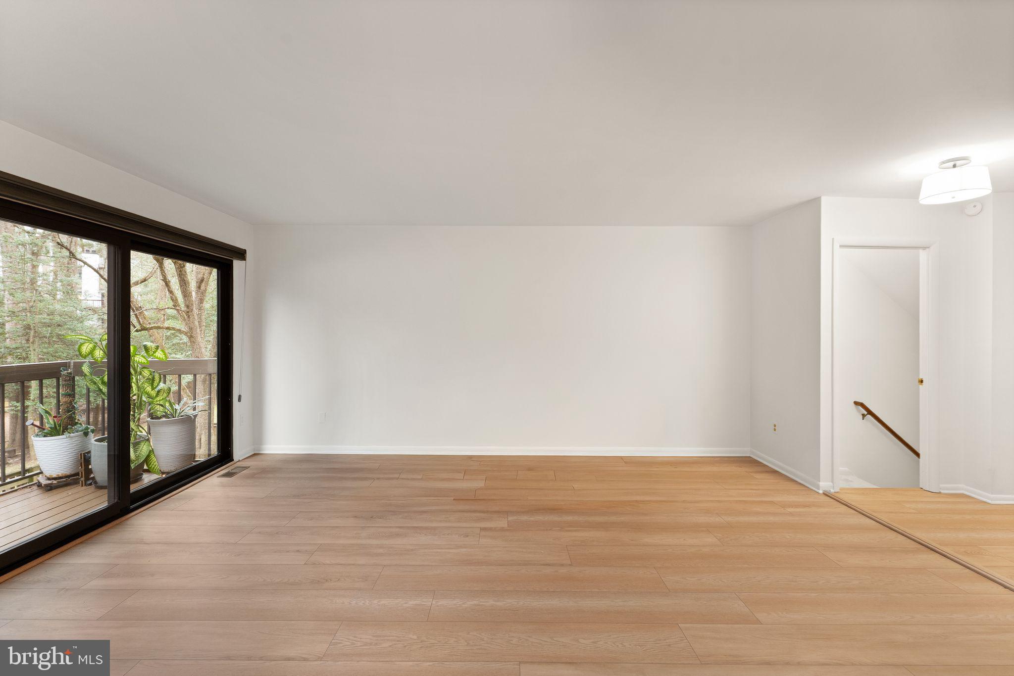 2345 Millennium Lane Reston, VA 20191 - Photo 21 of 55 a view of an empty room with wooden floor and a window