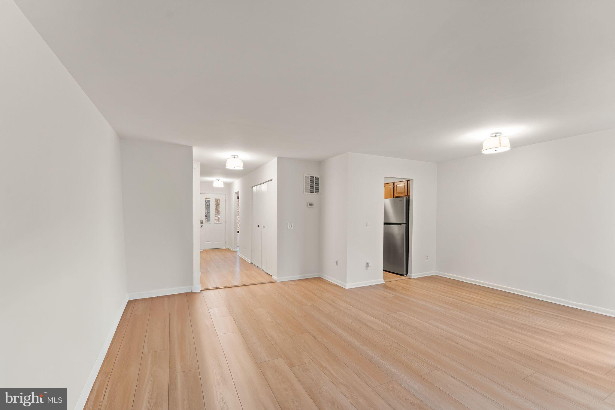 2345 Millennium Lane Reston, VA 20191 - Photo 3 of 55 a view of an empty room with wooden floor and windows