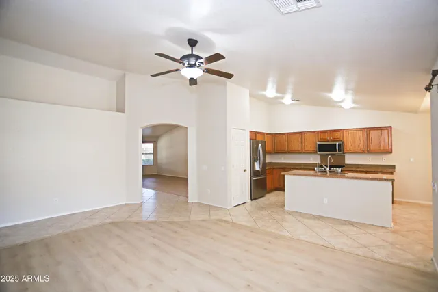 a view of a kitchen with a sink and a refrigerator