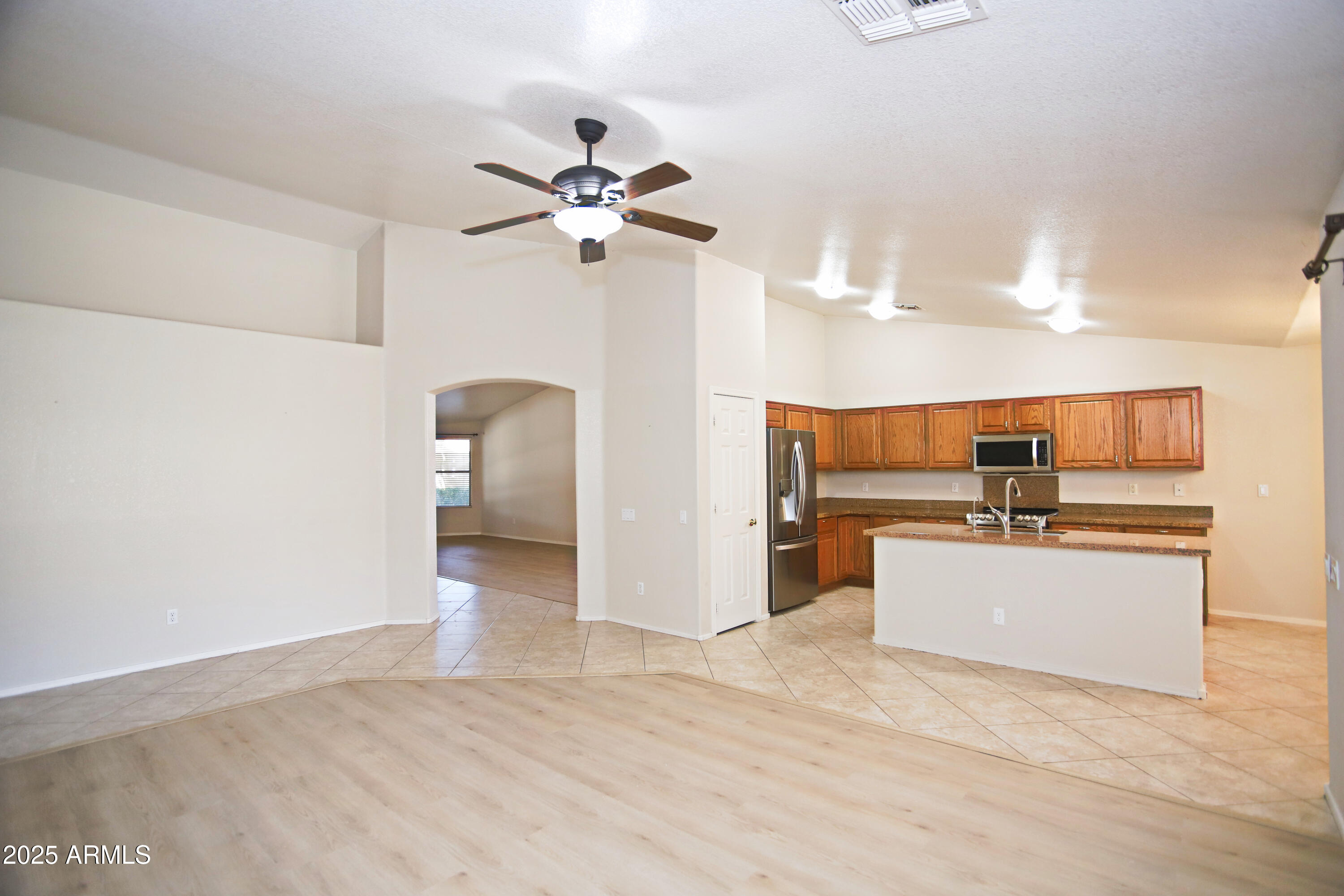 4953 South Moss Drive Chandler, AZ 85248 - Photo 14 of 50 a view of a kitchen with a sink and a refrigerator