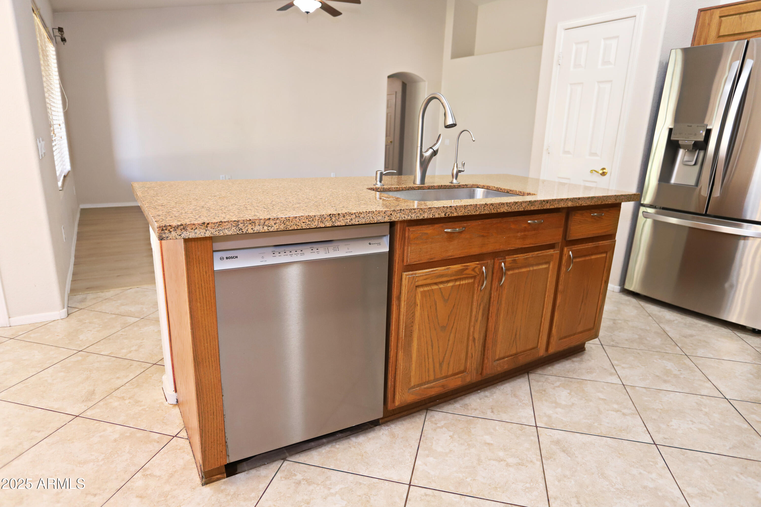 4953 South Moss Drive Chandler, AZ 85248 - Photo 18 of 50 a kitchen with stainless steel appliances granite countertop a refrigerator and a sink