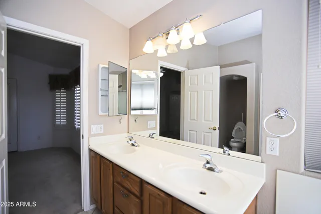 a bathroom with a double vanity sink and a mirror