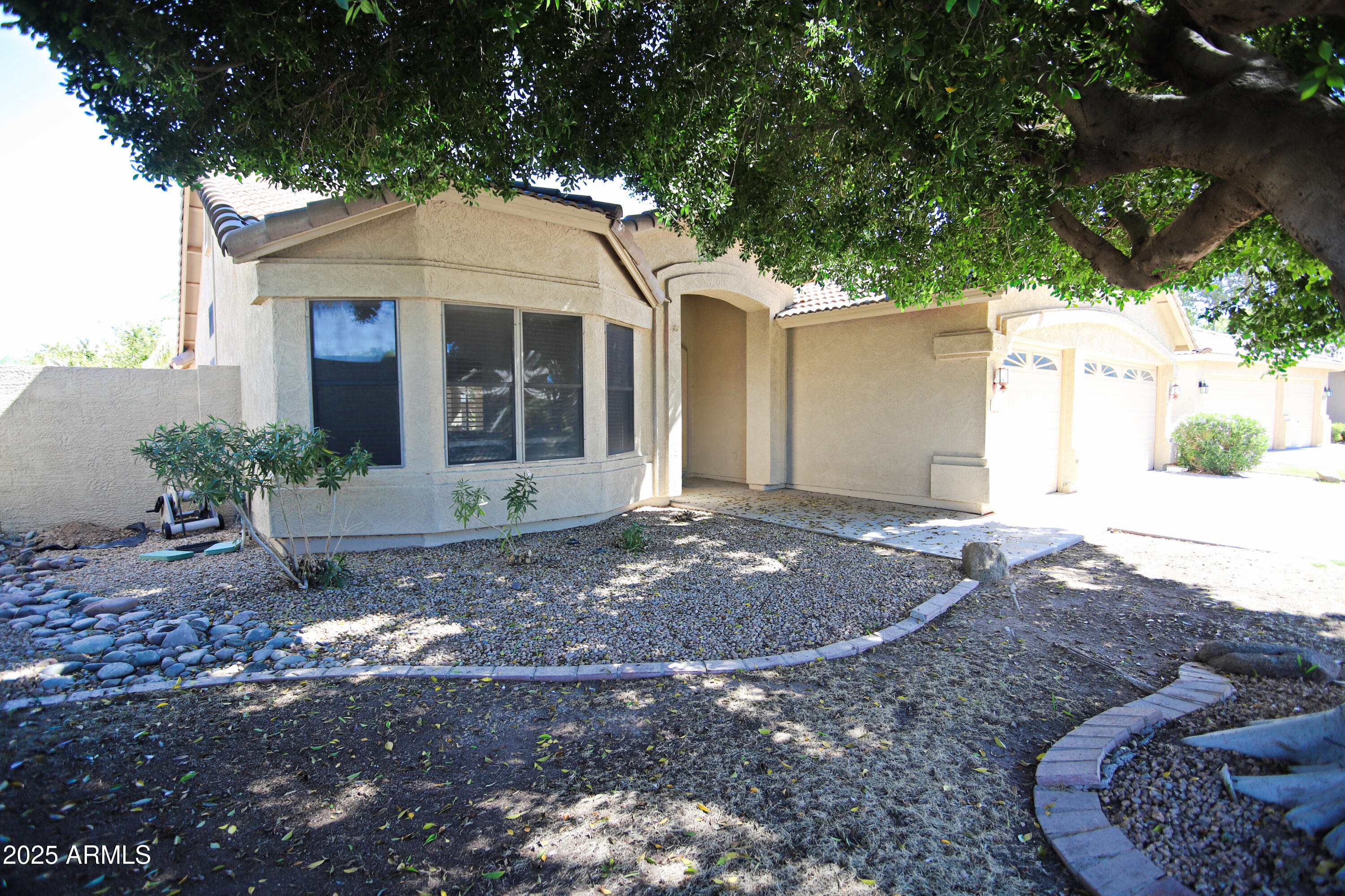 4953 South Moss Drive Chandler, AZ 85248 - Photo 3 of 50 a front view of a house with a yard