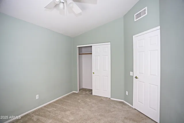 an empty room with a ceiling fan