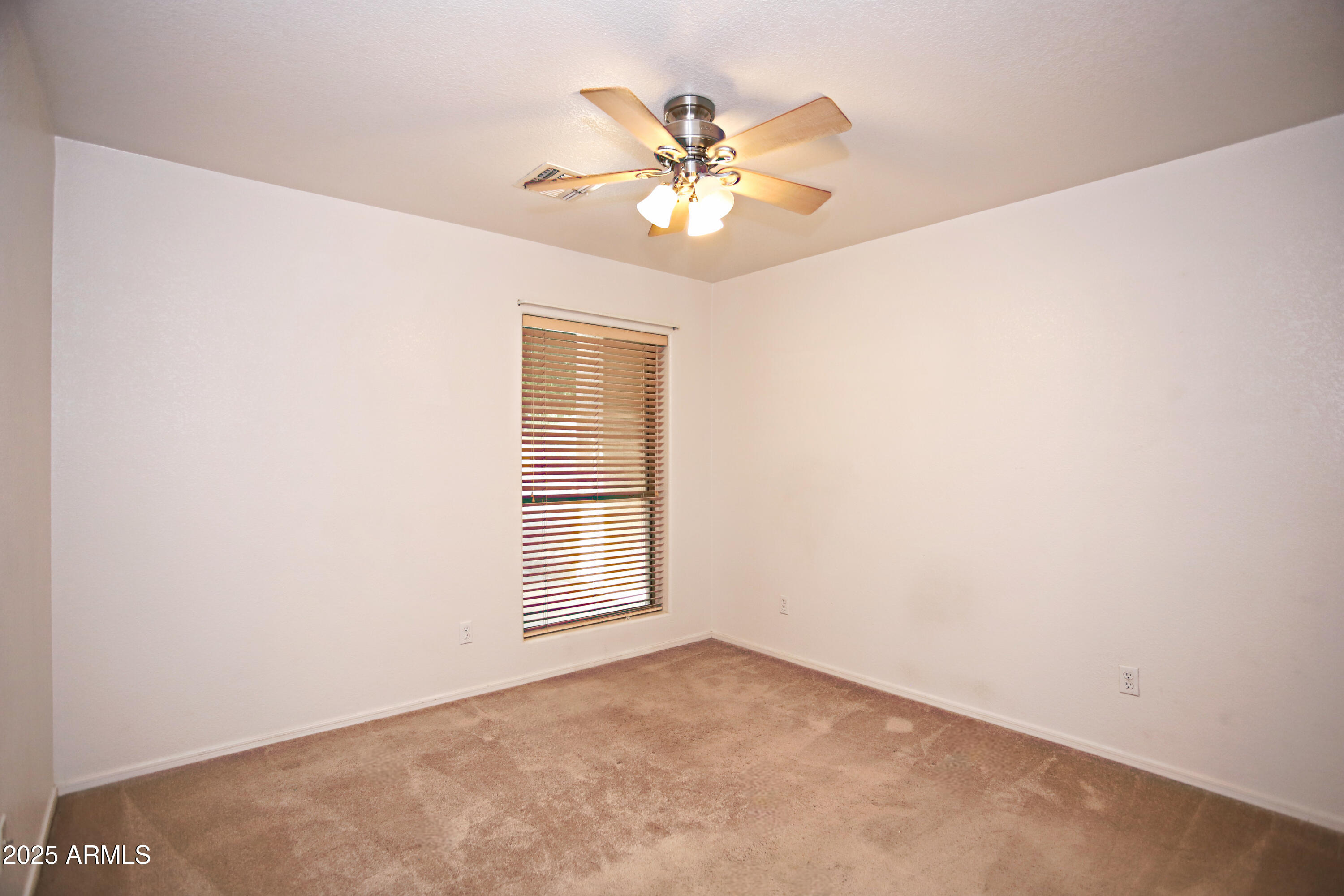 4953 South Moss Drive Chandler, AZ 85248 - Photo 36 of 50 an empty room with window and chandelier fan