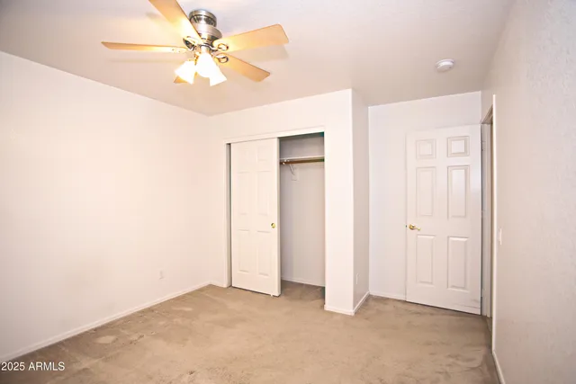 a view of a room with a ceiling fan