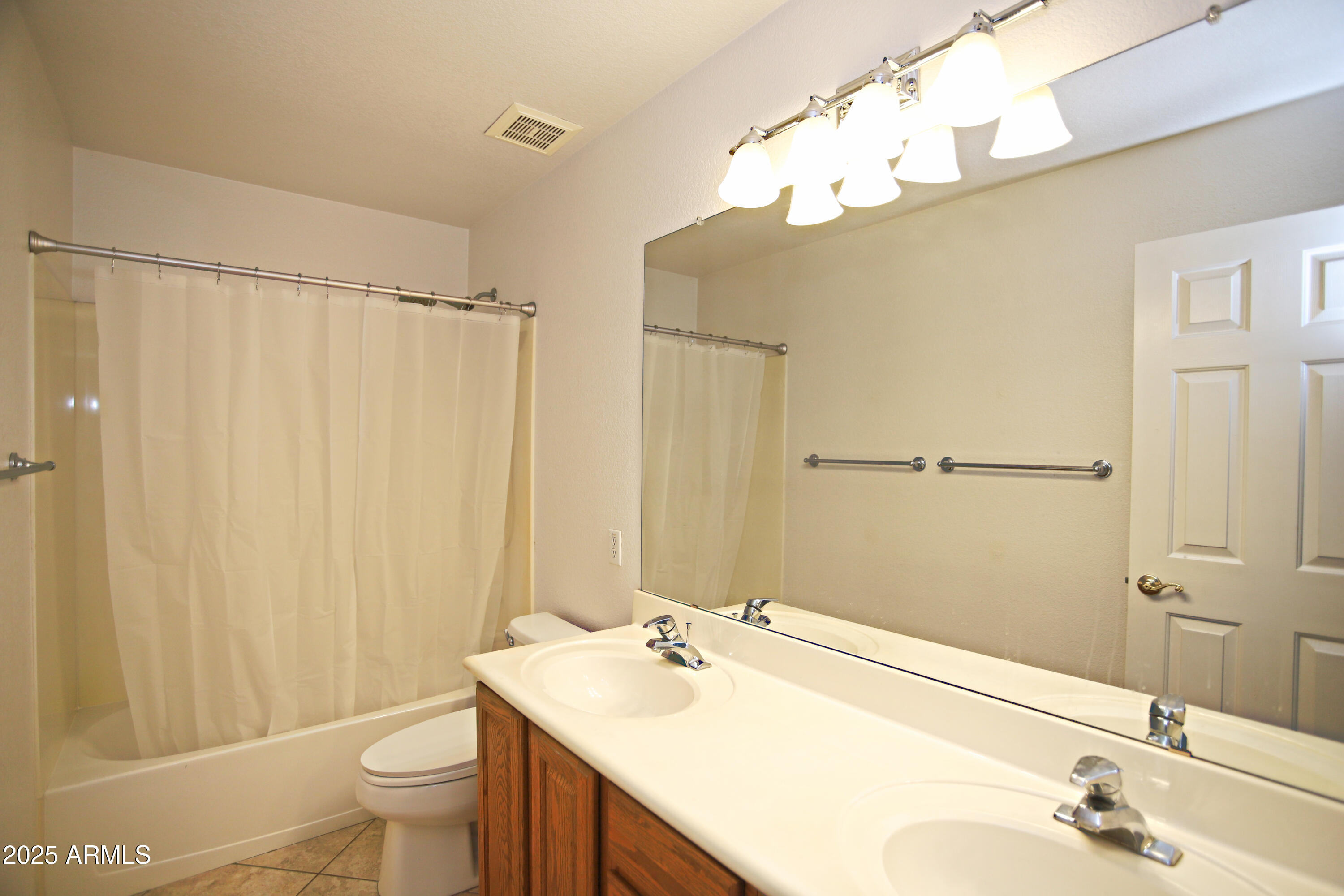 4953 South Moss Drive Chandler, AZ 85248 - Photo 38 of 50 a bathroom with a sink a toilet and shower curtain