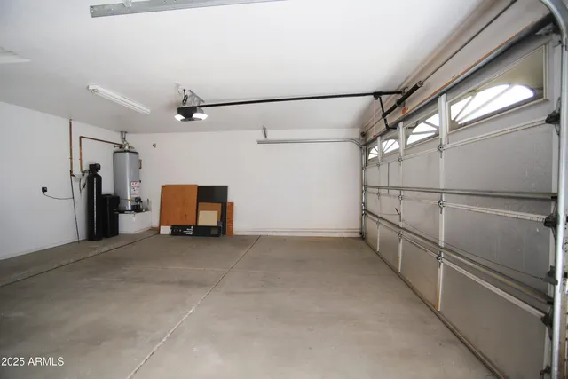 an empty room with windows & cabinet