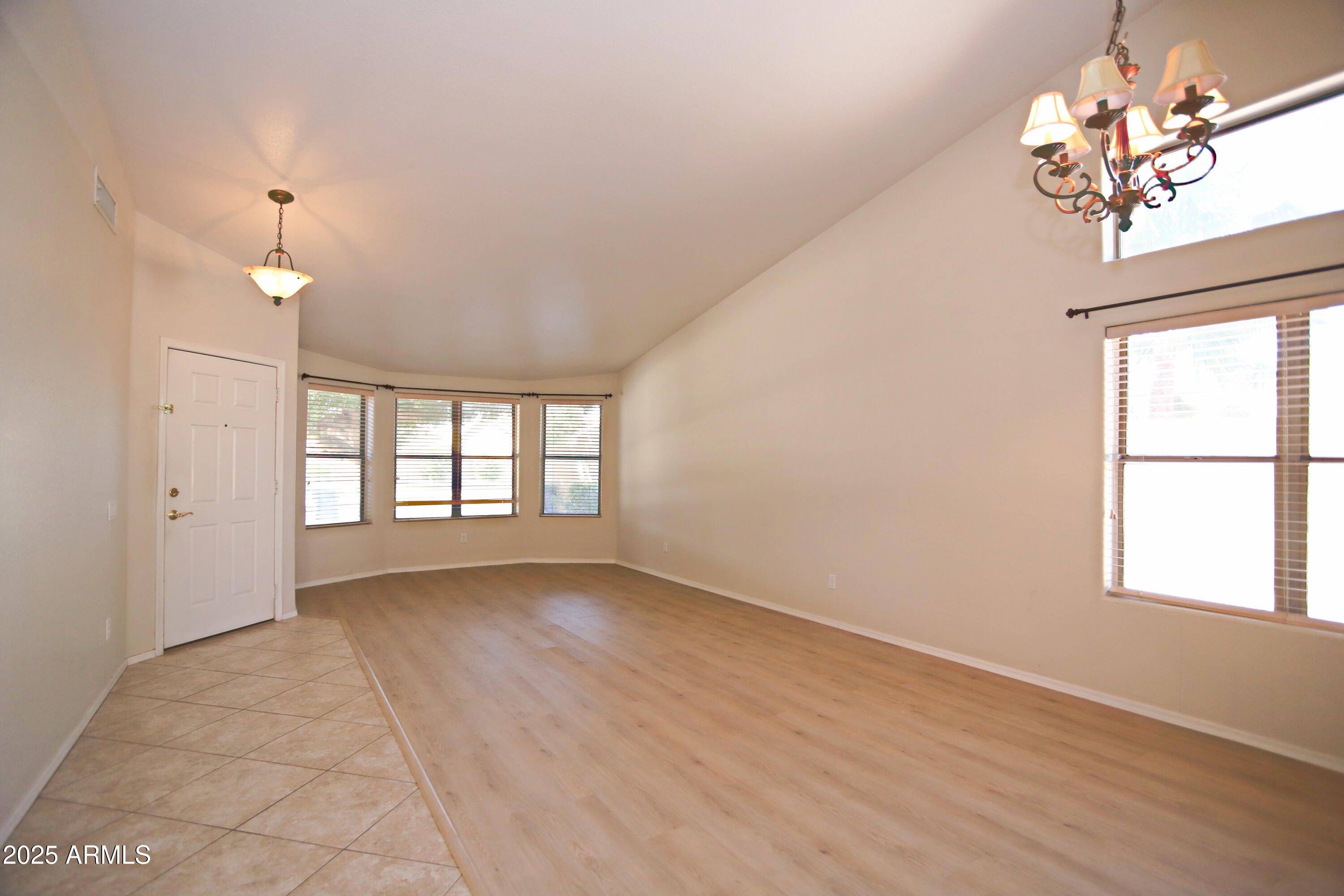4953 South Moss Drive Chandler, AZ 85248 - Photo 6 of 50 an empty room with chandelier fan and windows