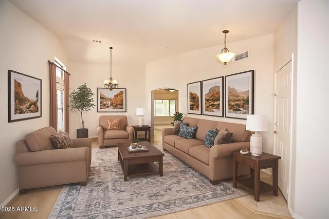 a living room with furniture wooden floor and a chandelier