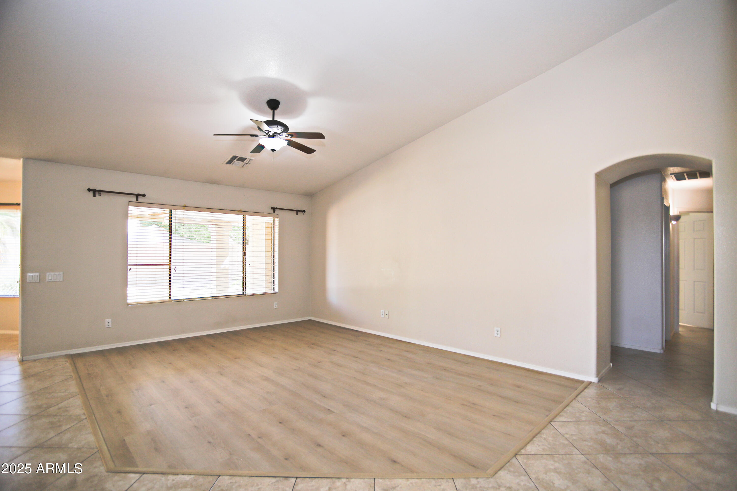 4953 South Moss Drive Chandler, AZ 85248 - Photo 9 of 50 wooden floor in an empty room with a window