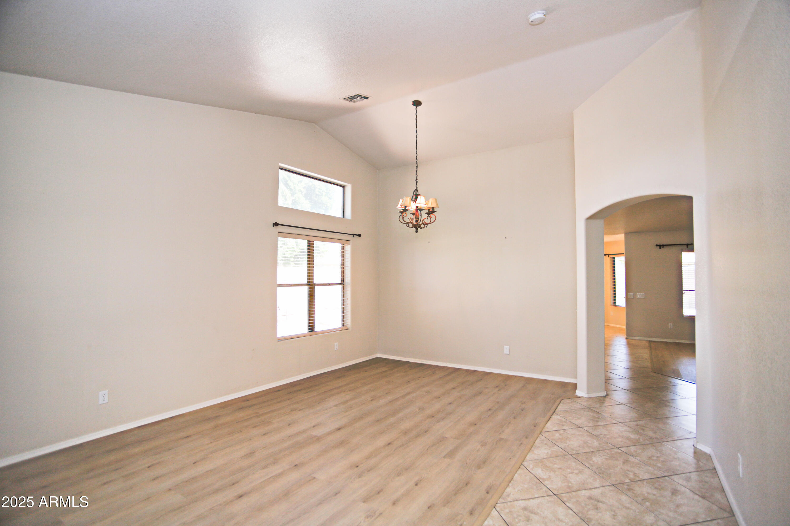 4953 South Moss Drive Chandler, AZ 85248 - Photo 10 of 50 an empty room with wooden floor and windows