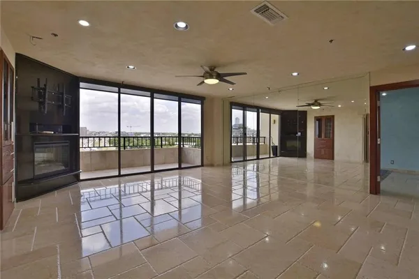 a lobby with a floor to ceiling window and stainless steel appliances