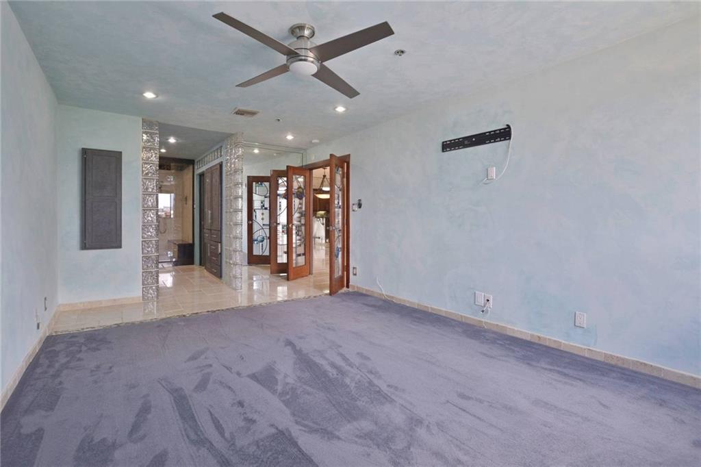 40 North Interstate Highway 35, Unit 12C2 Austin, TX 78701 - Photo 11 of 21 Carpeted spare room with baseboards and a ceiling fan