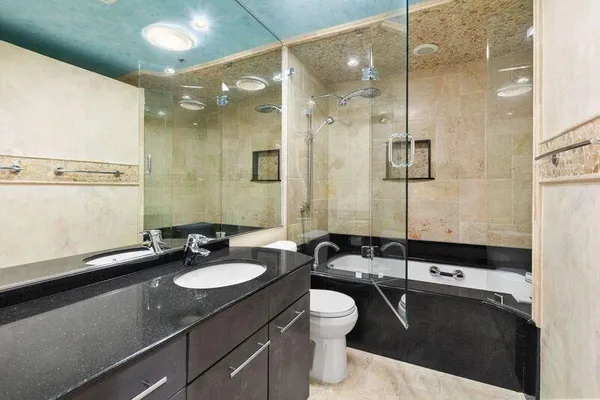a kitchen with stainless steel appliances granite countertop a sink refrigerator and cabinets