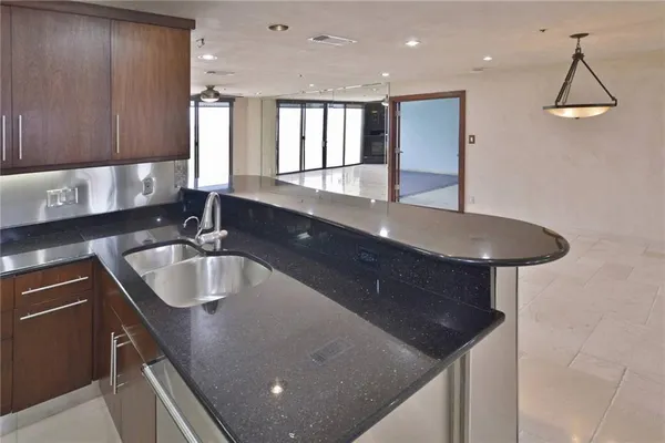 a kitchen with a sink a stove and cabinets