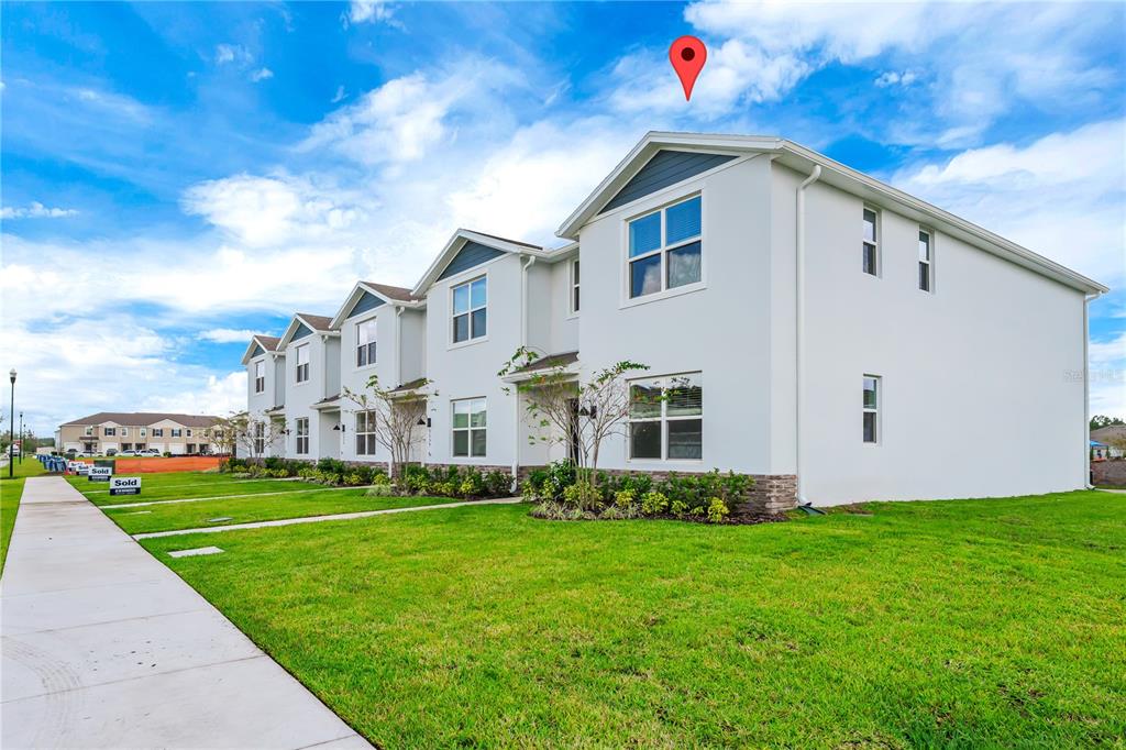 5650 Anders Way St. Cloud, FL 34771 - Photo 2 of 39 a front view of a house with garden