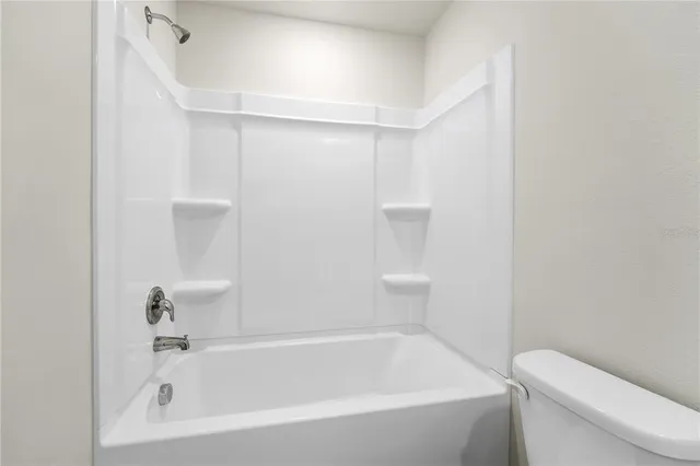 a bathroom with a bathtub and toilet