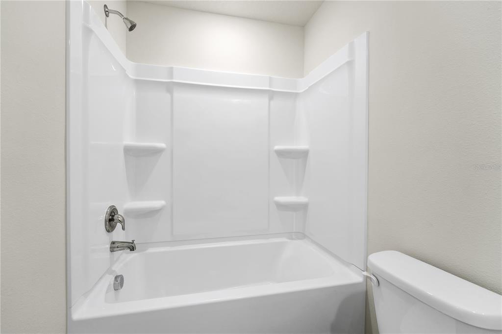 5650 Anders Way St. Cloud, FL 34771 - Photo 22 of 39 a bathroom with a bathtub and toilet