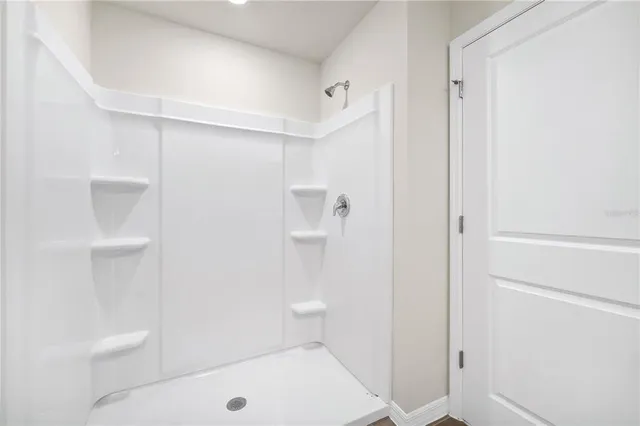 a bathroom with a shower and toilet