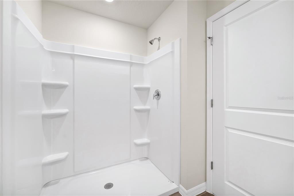 5650 Anders Way St. Cloud, FL 34771 - Photo 27 of 39 a bathroom with a shower and toilet