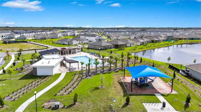 an aerial view of a house with a swimming pool outdoor seating and yard