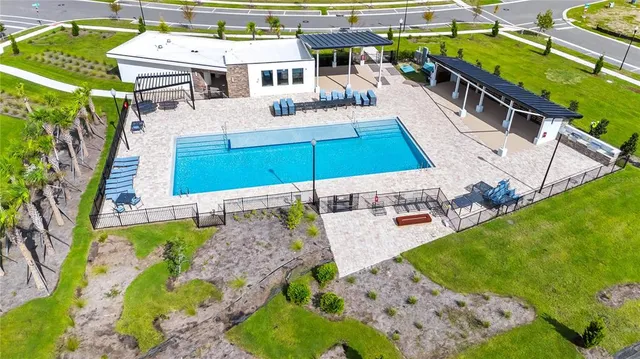 a view of a backyard with swimming pool