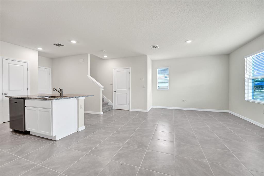 5650 Anders Way St. Cloud, FL 34771 - Photo 8 of 39 a view of an empty room with kitchen and window