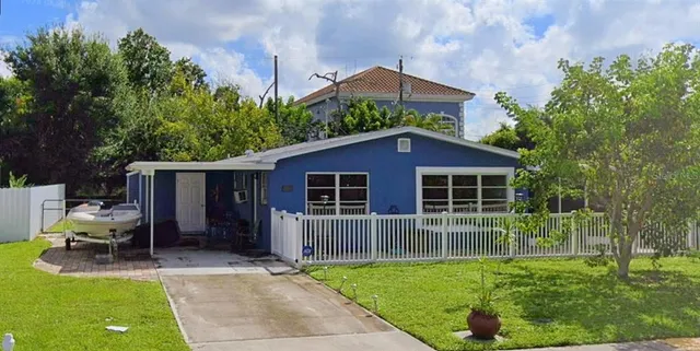 a view of house with backyard and furniture