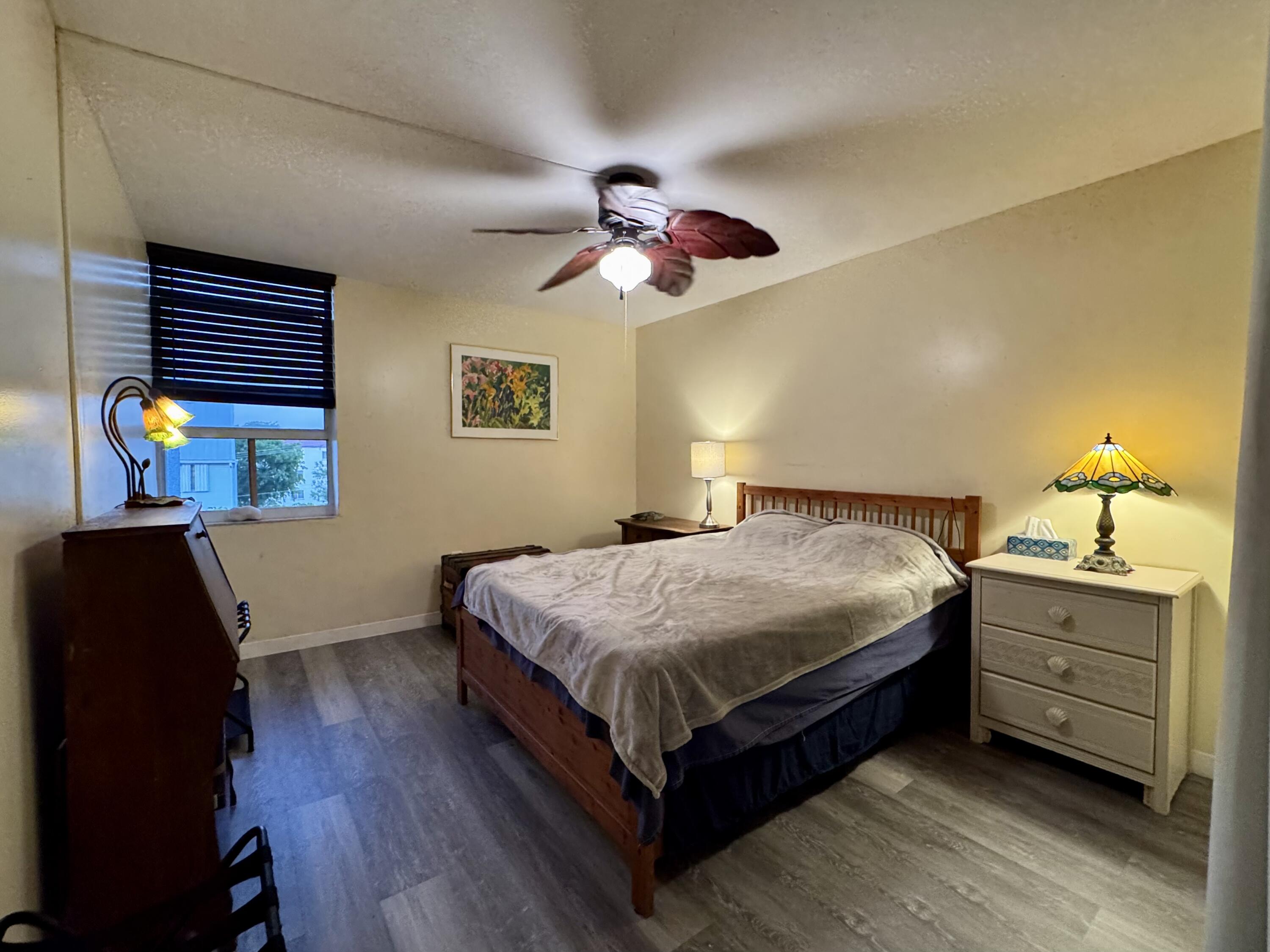3312 Northside Drive, Unit 405 Key West, FL 33040 - Photo 11 of 25 a bedroom with a bed and a chandelier