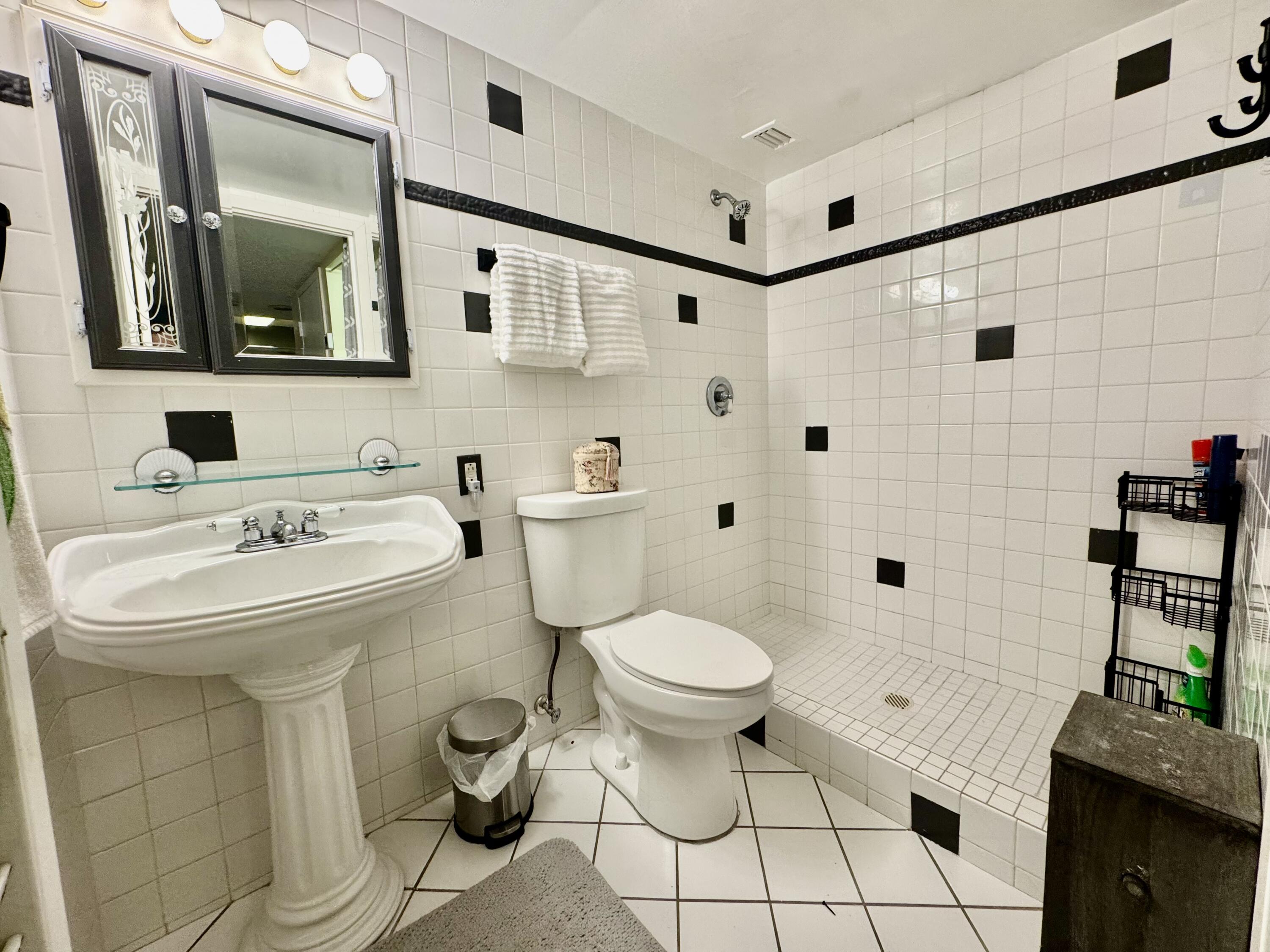 3312 Northside Drive, Unit 405 Key West, FL 33040 - Photo 12 of 25 a bathroom with a sink toilet and shower