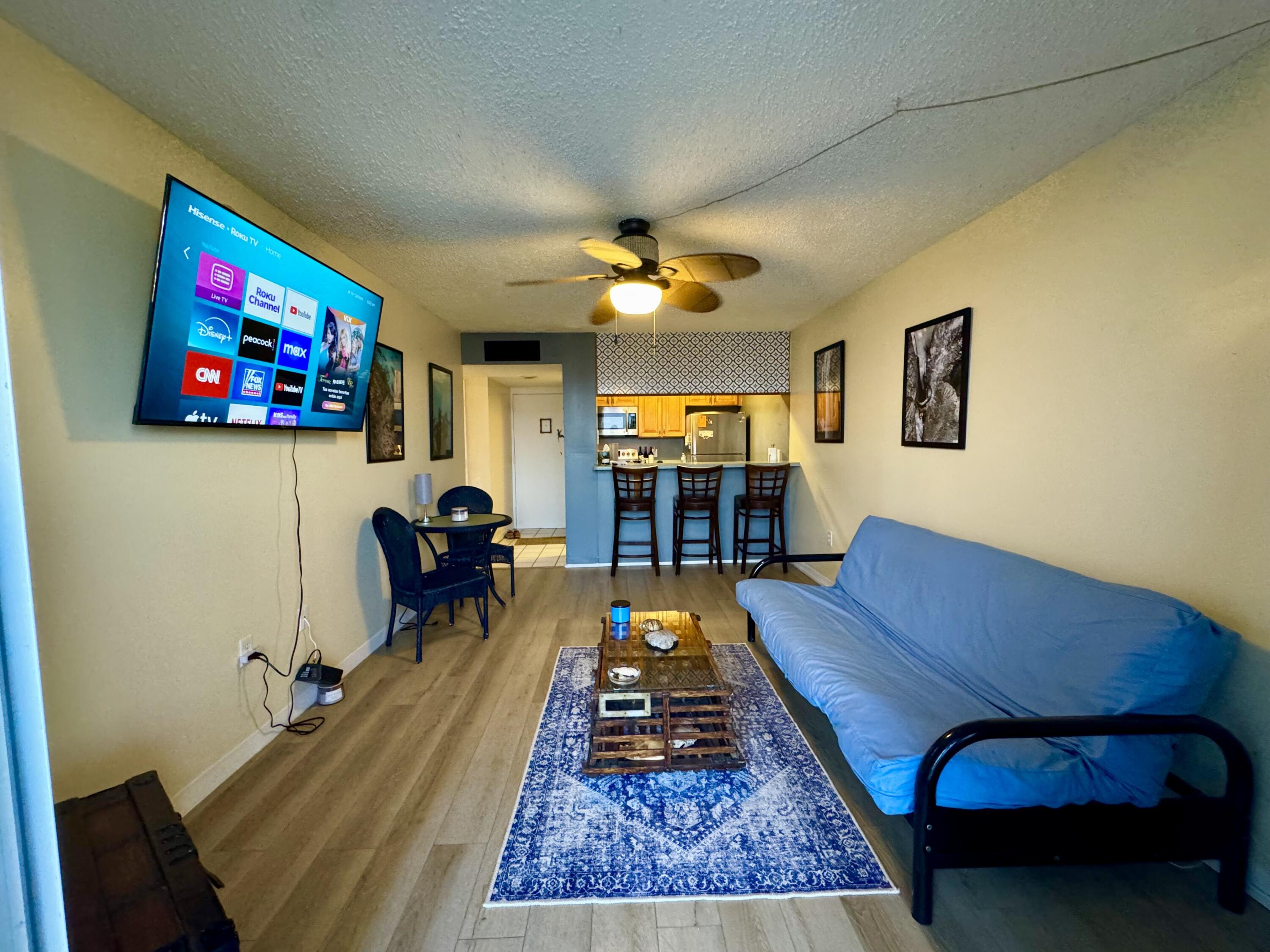 3312 Northside Drive, Unit 405 Key West, FL 33040 - Photo 4 of 25 a living room with furniture a rug and a flat screen tv