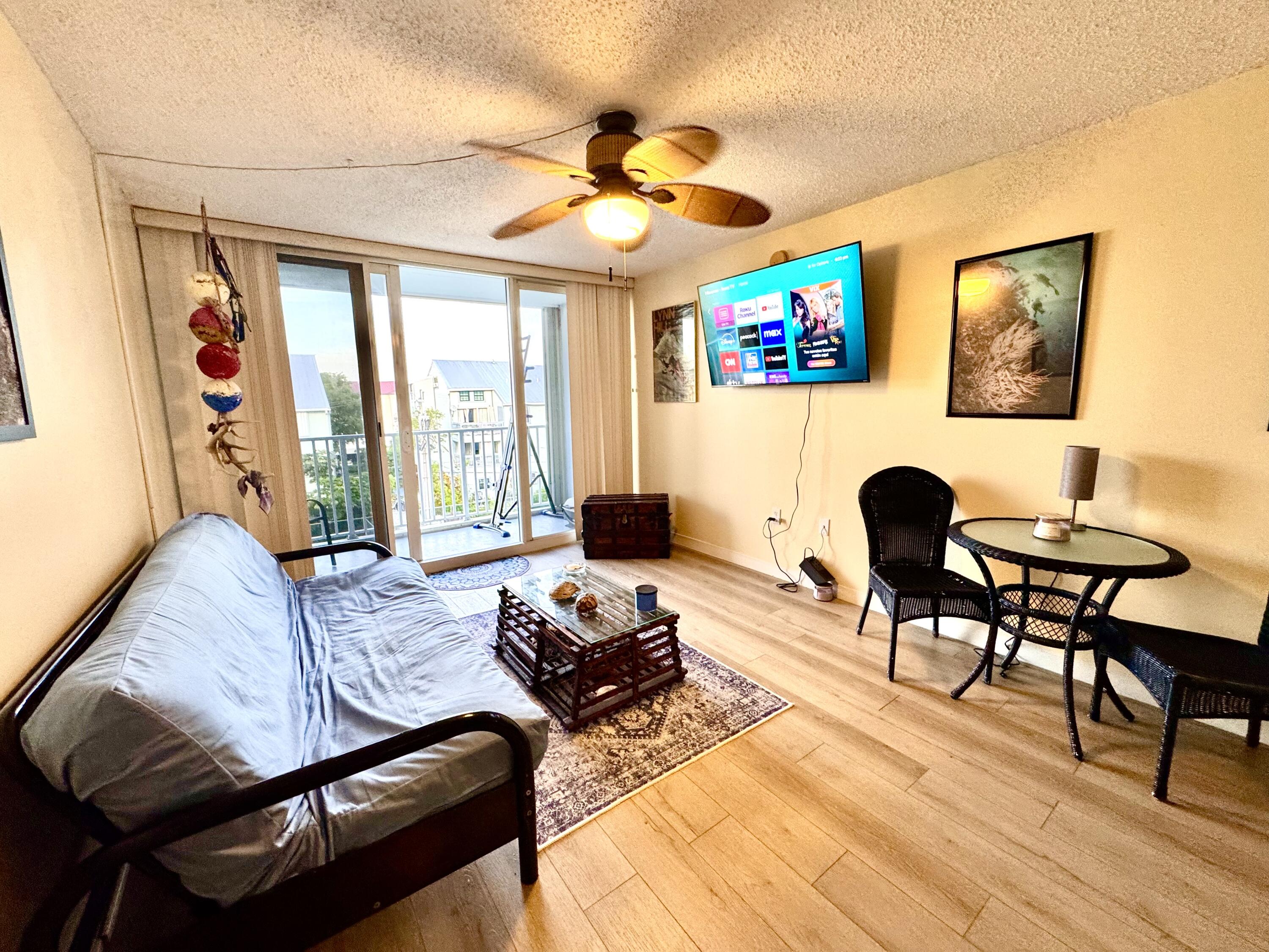 3312 Northside Drive, Unit 405 Key West, FL 33040 - Photo 5 of 25 a living room with furniture and a flat screen tv