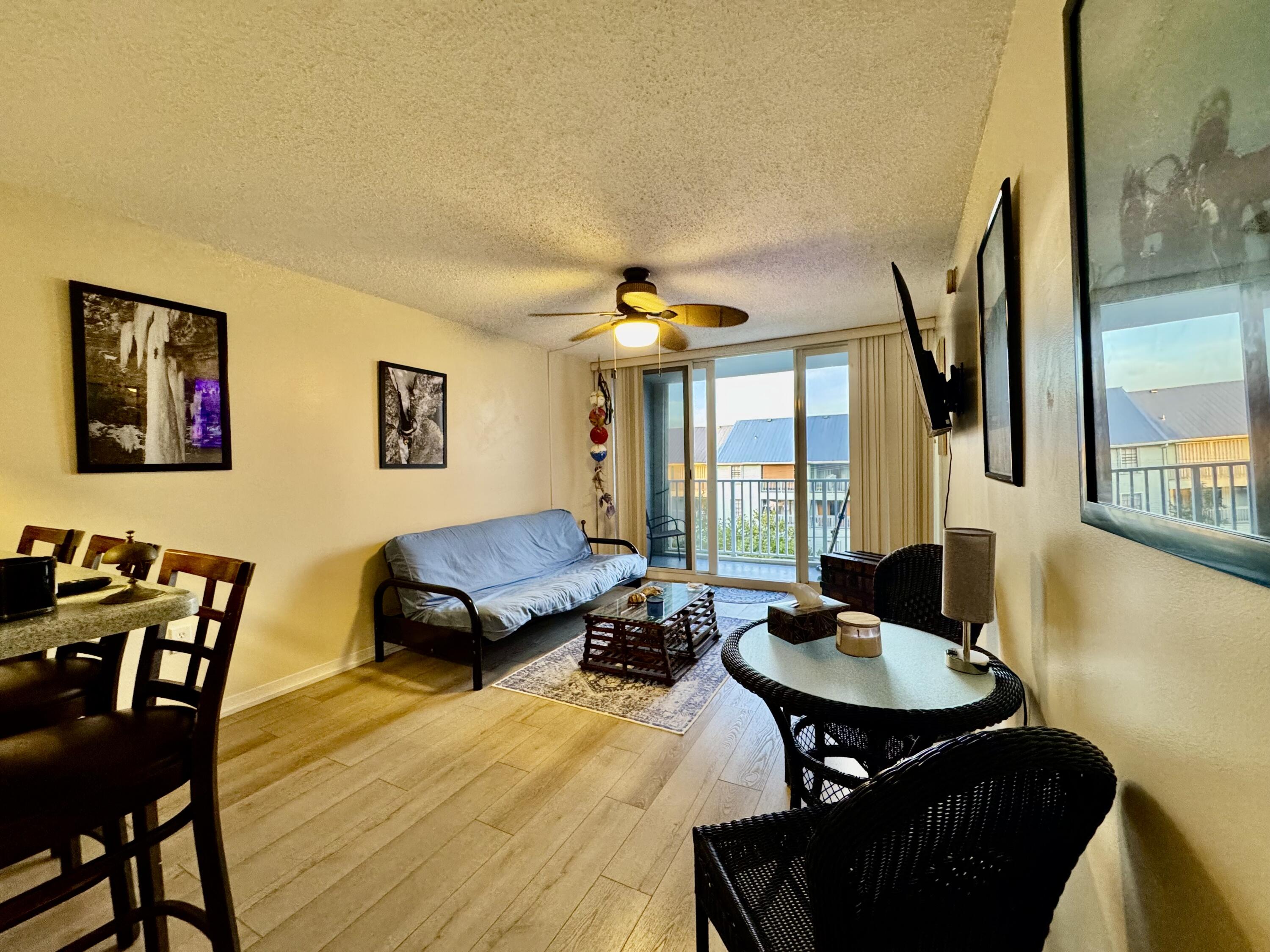3312 Northside Drive, Unit 405 Key West, FL 33040 - Photo 6 of 25 a living room with furniture a window and a flat screen tv