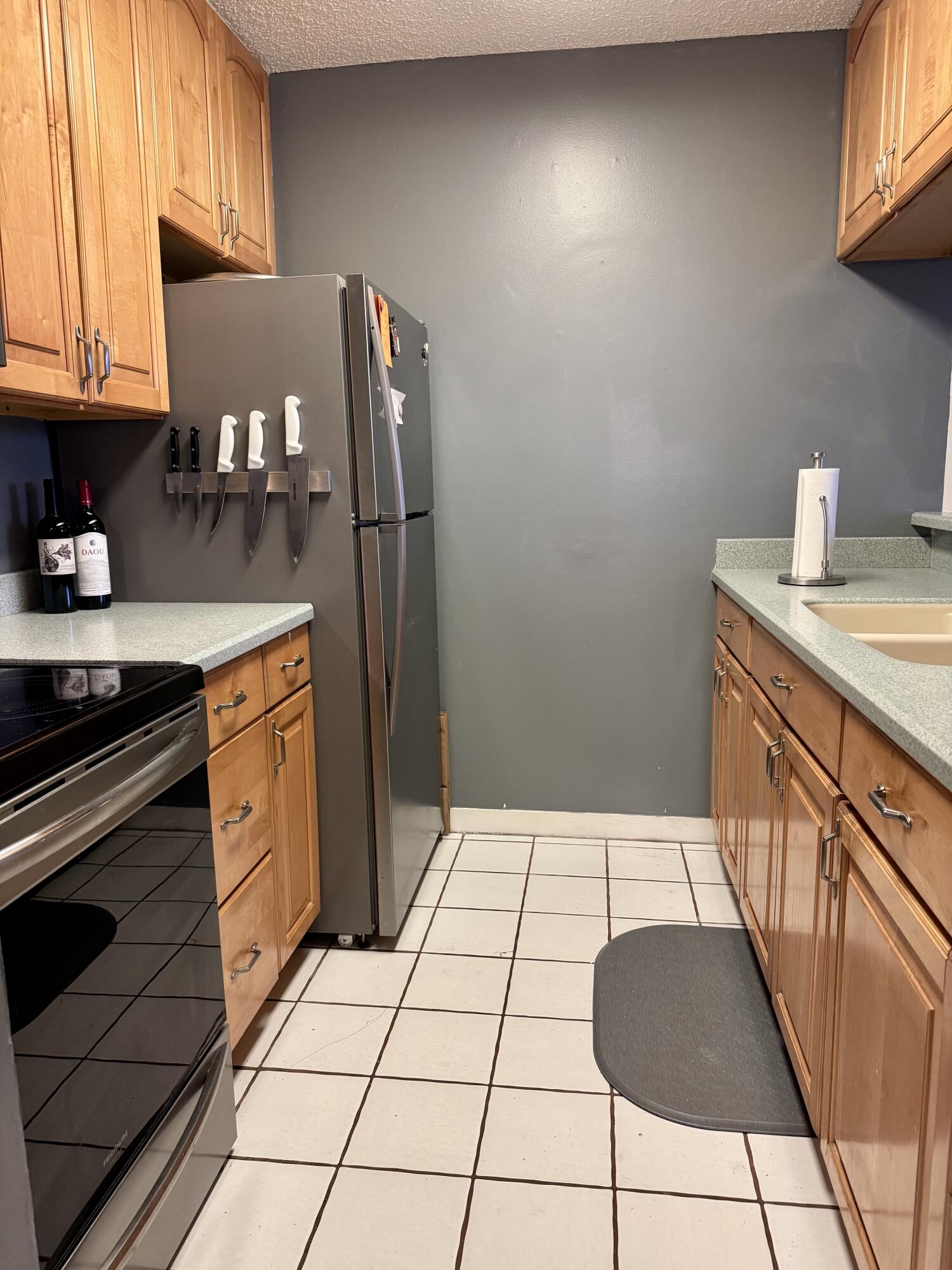 3312 Northside Drive, Unit 405 Key West, FL 33040 - Photo 9 of 25 a kitchen with stainless steel appliances a refrigerator sink and cabinets