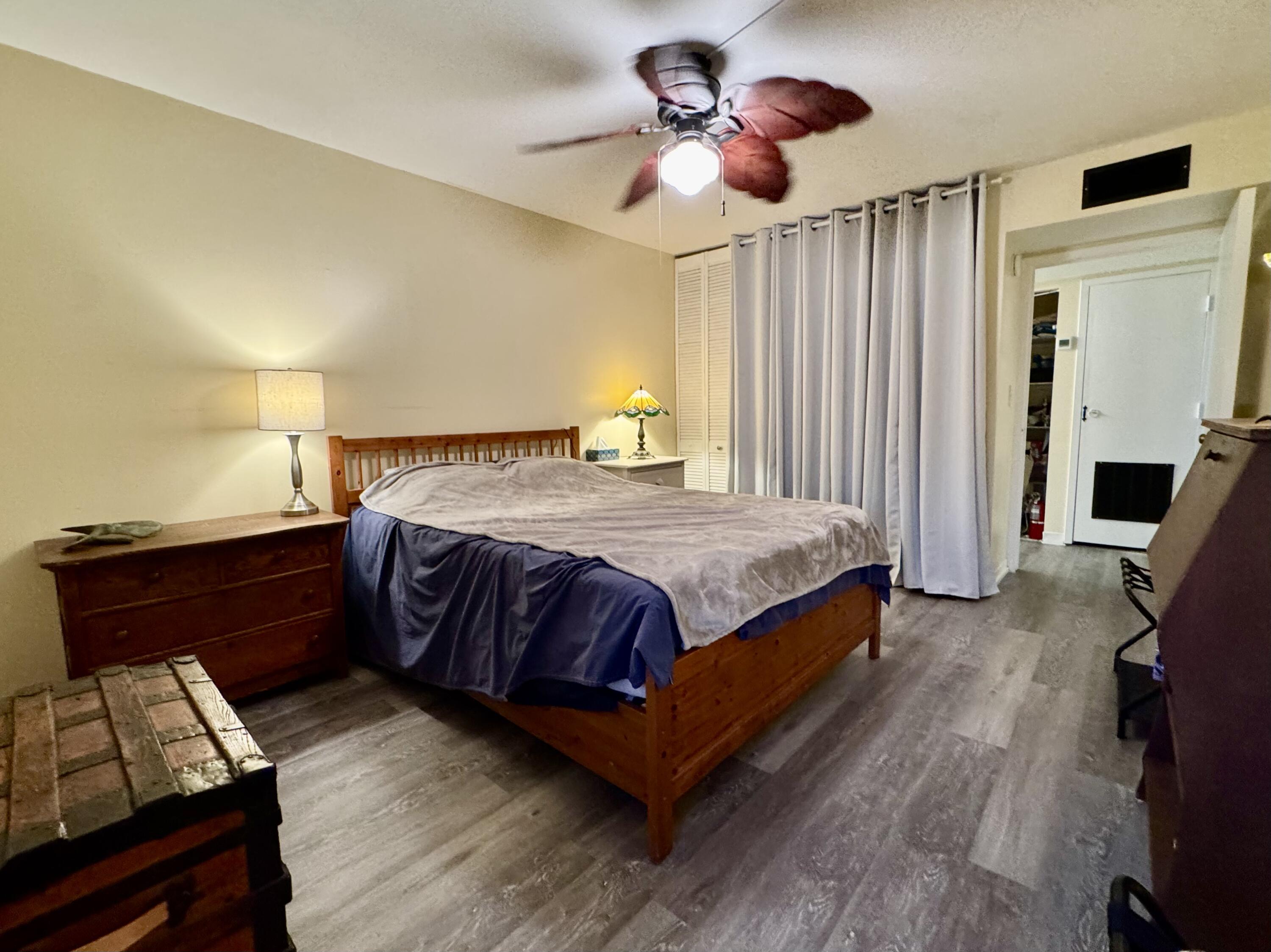 3312 Northside Drive, Unit 405 Key West, FL 33040 - Photo 10 of 25 a bedroom with a bed and a chandelier