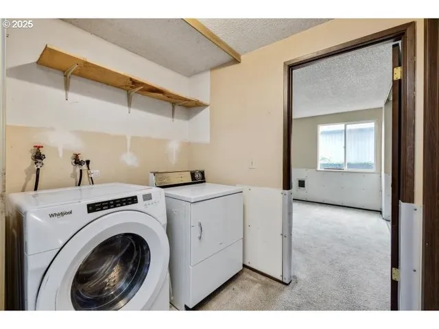 a view of storage and utility room with washer and dryer
