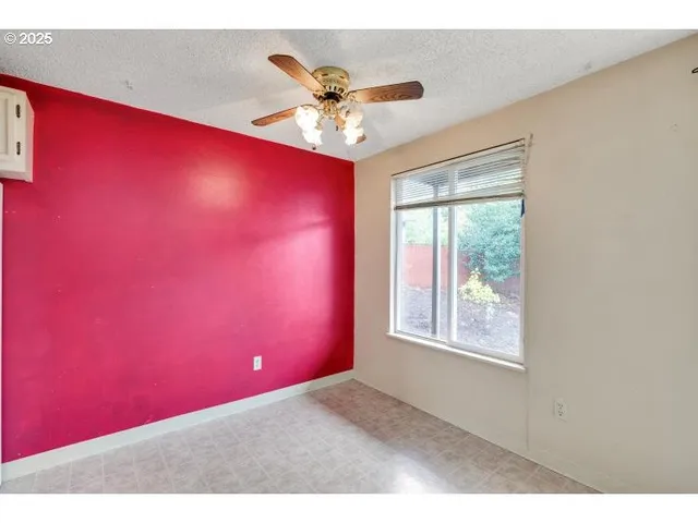 a blue room with windows and ceiling fan