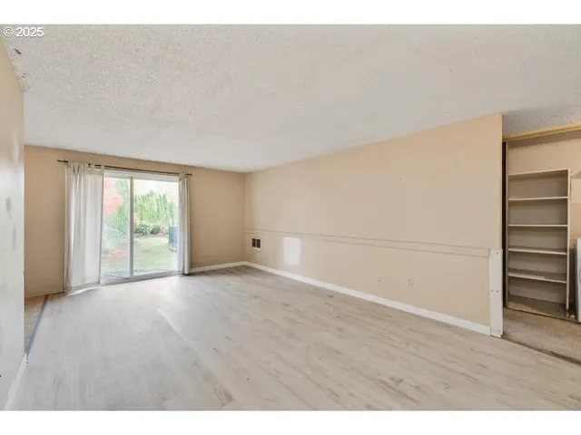 a view of an empty room with a window