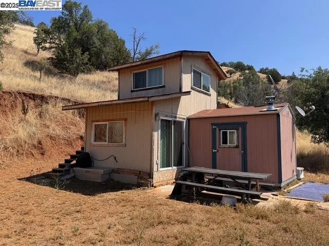 a view of a house with a yard and wooden floor