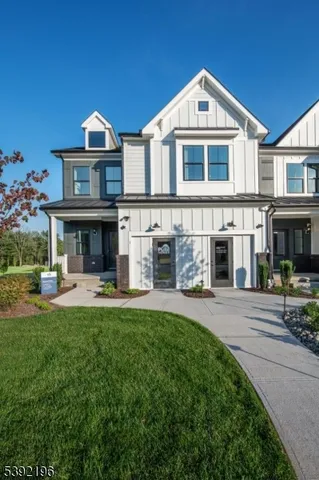 a front view of a house with a yard table and chairs