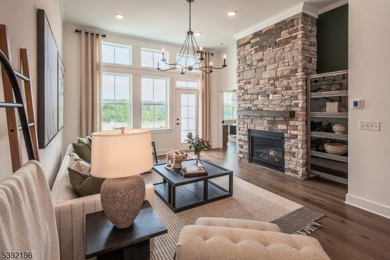 20 Whitaker Lane Far Hills, NJ 07931 - Photo 6 of 18 a living room with furniture a fireplace and a chandelier